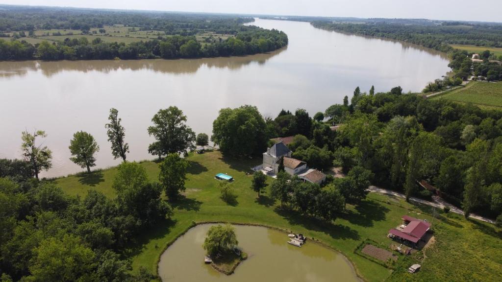 an aerial view of a house next to a river at Le Cast'L 2 Coin de paradis en bord de Dordogne in La Rivière