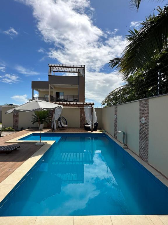 uma piscina em frente a uma casa em RECANTO DAS ÁGUAS VILLE em Santo Amaro