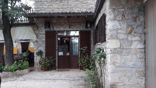 a stone house with a wooden door and a porch at Agriturismo Giacomo Alberione in Roccavivara