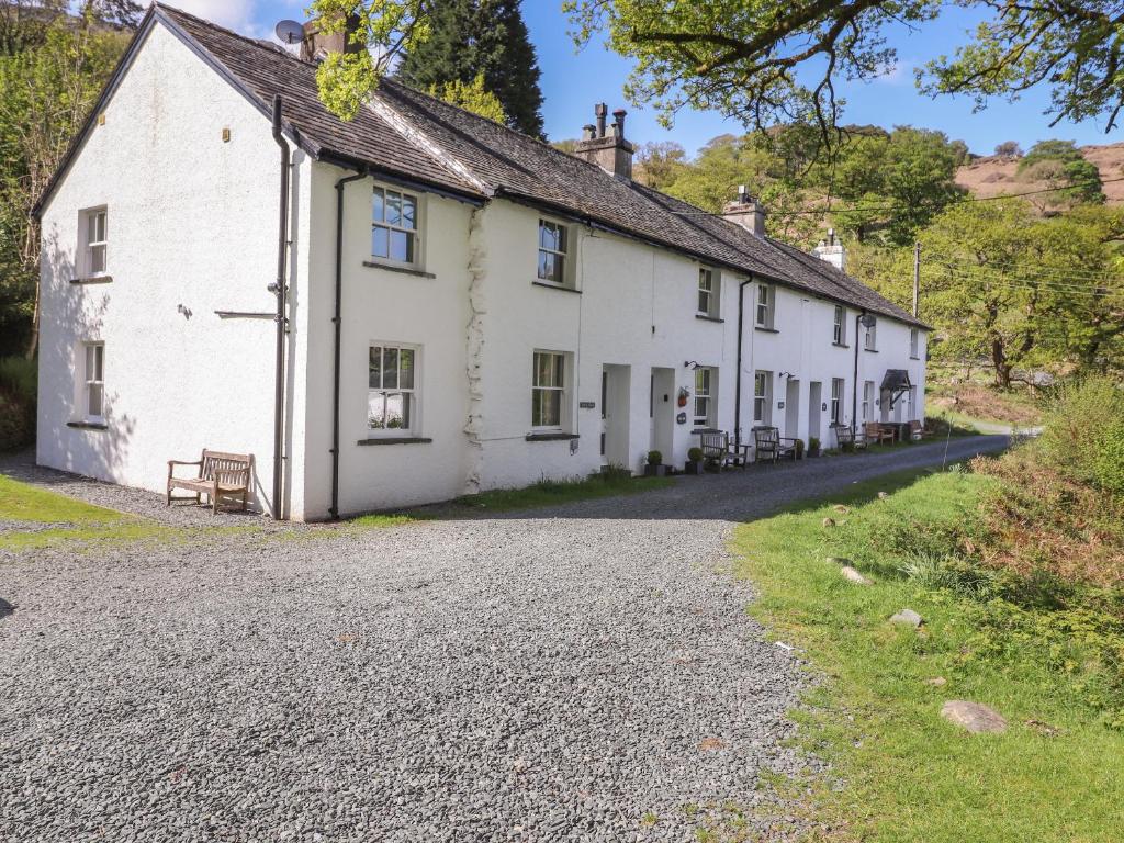 a row of white houses on a gravel road at High Stile in Keswick