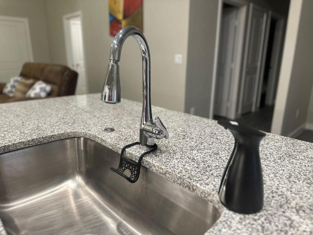 a kitchen sink with a faucet on a counter at Brand New Cute Home in Odessa near Midland in Odessa