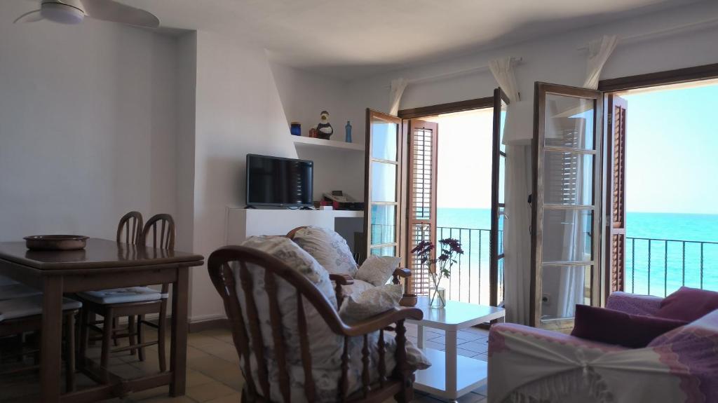 a living room with a view of the ocean at Baywatch Penthouse in Altafulla