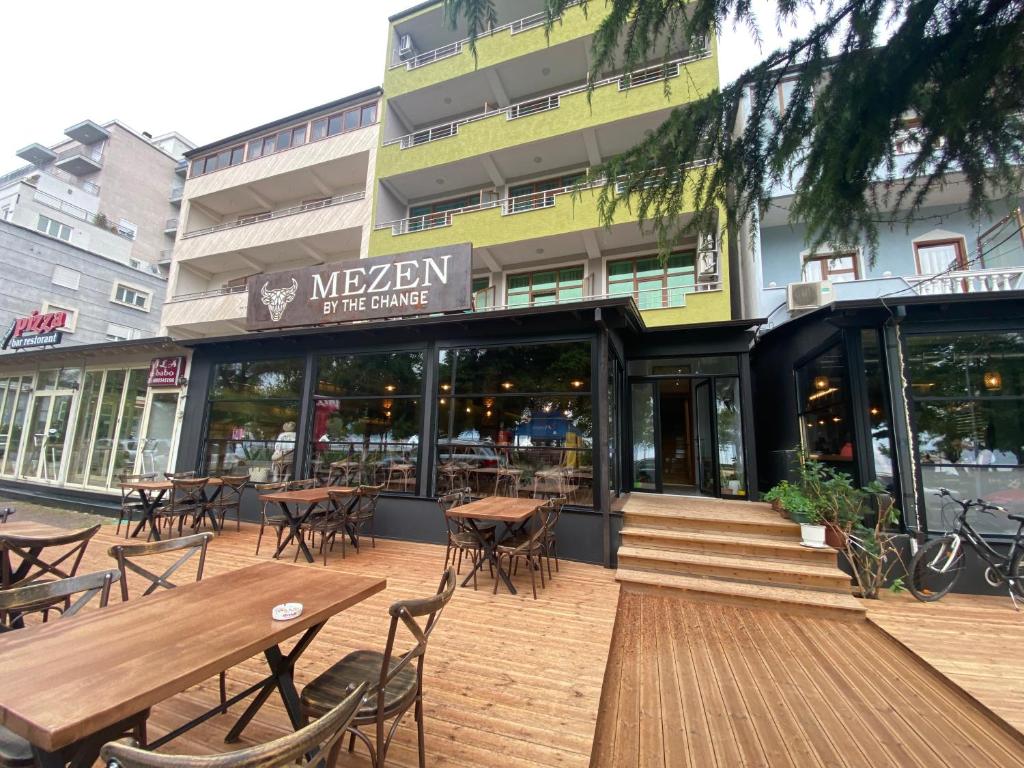 a restaurant with tables and chairs in front of a building at Vila Vadeha in Pogradec