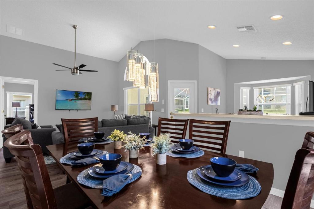 a dining room and living room with a table and chairs at Amazing 4 Bedrooms 3 Bath with private pool, near Disney and Universal! in Davenport