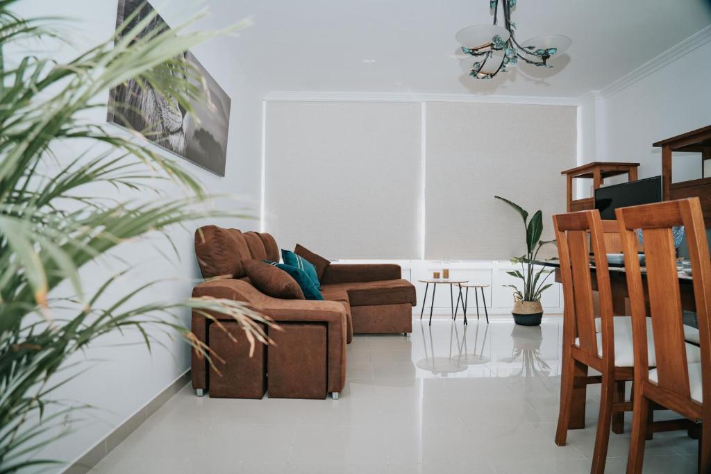 a living room with two couches and a table at Meu Lar in Rianjo