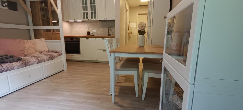 a kitchen with a table and chairs in a room at Casa Natura in Castione della Presolana