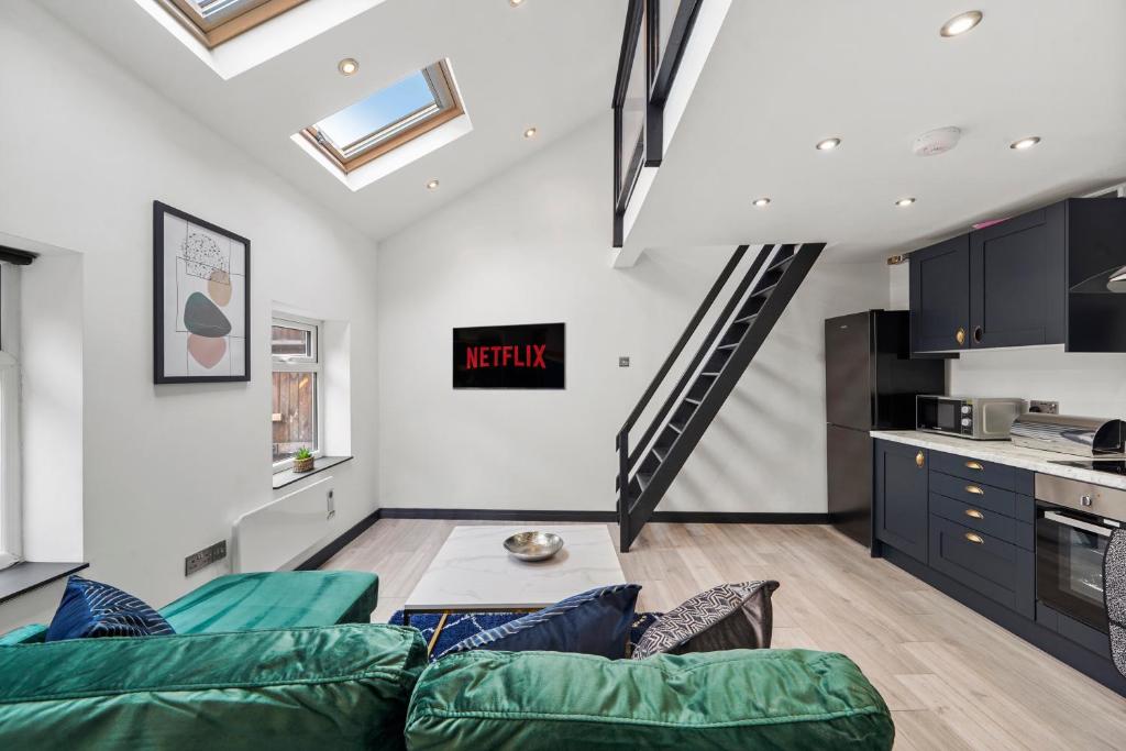 a living room with a couch and a kitchen at New York Living in Yorkshire in Castleford