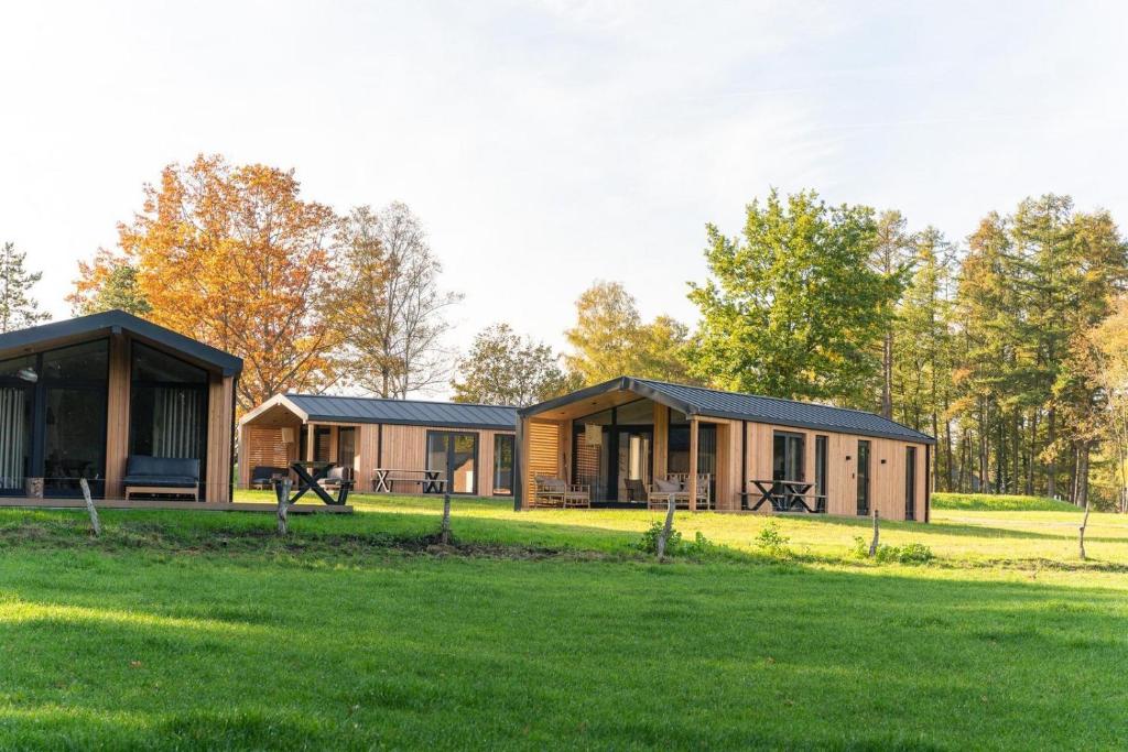 a cabin in the woods with a grass field at The Valley x Wilsum in Wilsum