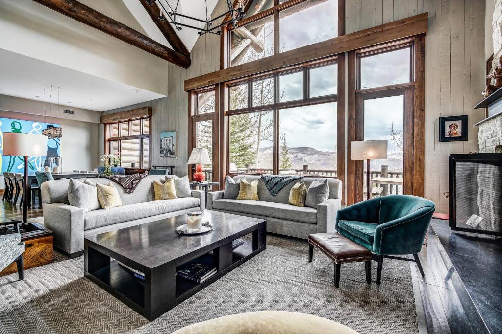 a living room with a couch and a table at Bachelor Gulch Horizon Pass Private Townhome in Beaver Creek