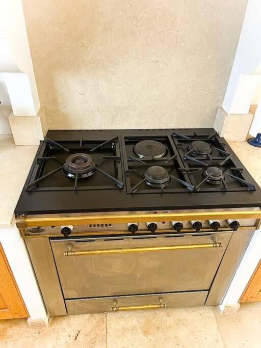 a stove top oven sitting in a kitchen at Belle villa avec jardin piscine et salle de sport in Montauroux