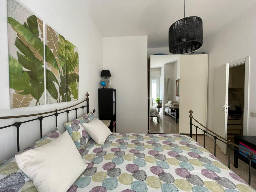 a bedroom with a bed and a painting on the wall at Apartment 4 people in Rimini 400m from the beach in Rimini
