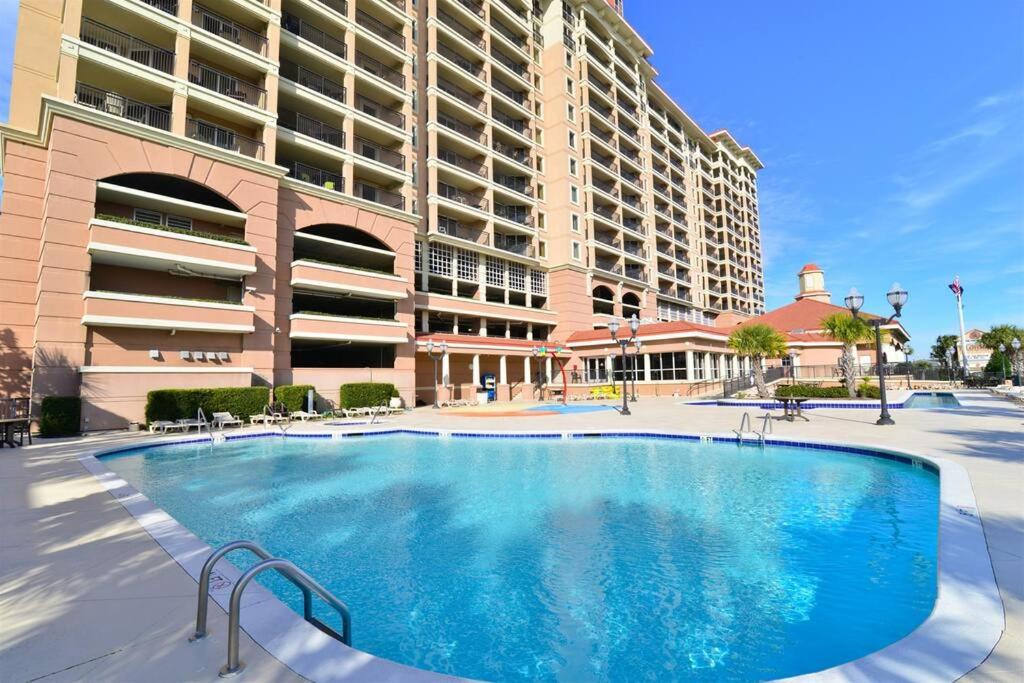 a large swimming pool in front of a large building at Tilghman Resort Ocean View Paradise Aw Lazy River & Indoor Outdoor Pools in Myrtle Beach
