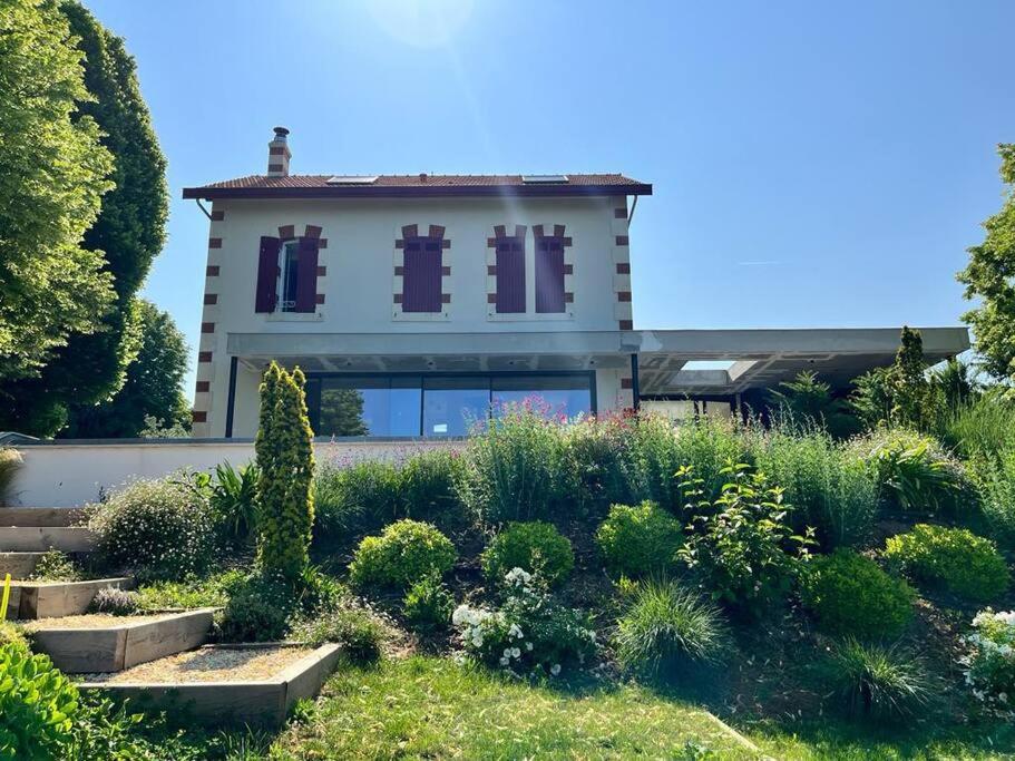a house with a garden in front of it at Les Palissières in Mortagne-sur-Gironde
