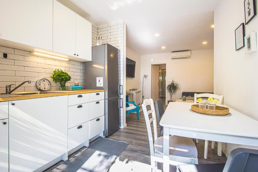 a kitchen and dining room with a table and chairs at Apartments Prgomet in Makarska