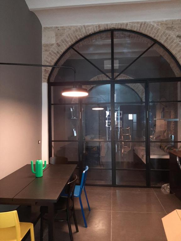 a dining room with a table and a large window at Urban79 in Bernalda