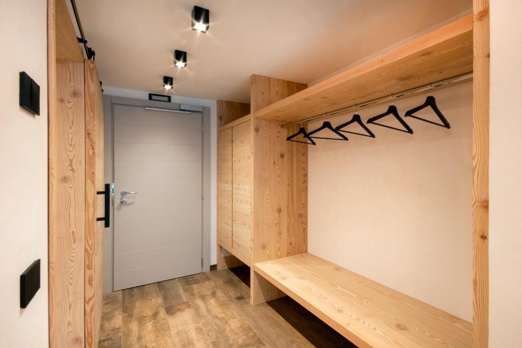 a walk in closet with wooden walls and a door at BORMIO N'JOY in Bormio