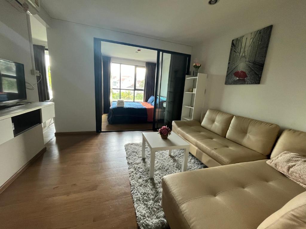 a living room with a couch and a table at 1 bedroom Centrio Condominium Phuket Near Central Festival in Phuket town in Phuket Town