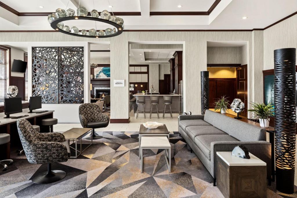 a lobby of a hotel with a couch and chairs at Sheraton Duluth Hotel in Duluth