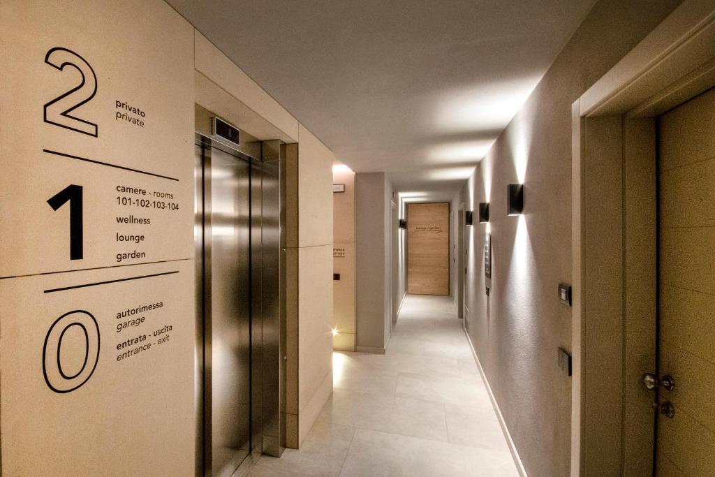 a hallway with a sign on the wall of a building at BORMIO N'JOY in Bormio