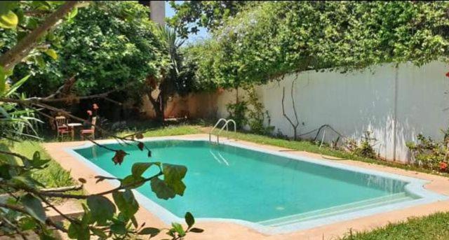 a swimming pool in the backyard of a house at Lhaja home in Casablanca