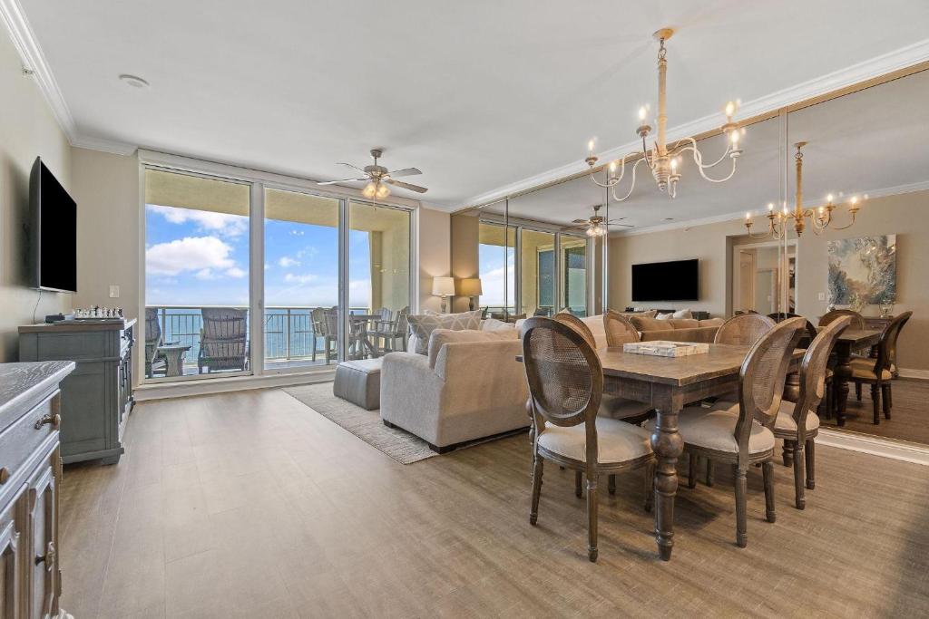 a dining room and living room with a view of the ocean at Indigo East 1004 in Perdido Key