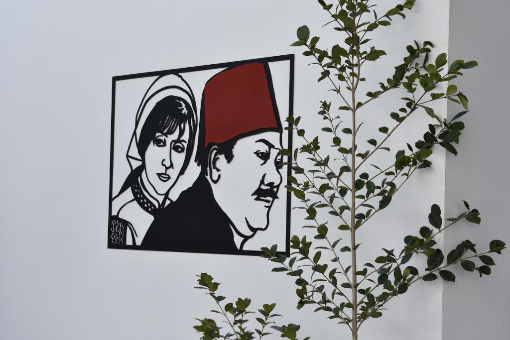 a picture of a man and a woman on a wall at Zoi Ayia Napa in Ayia Napa