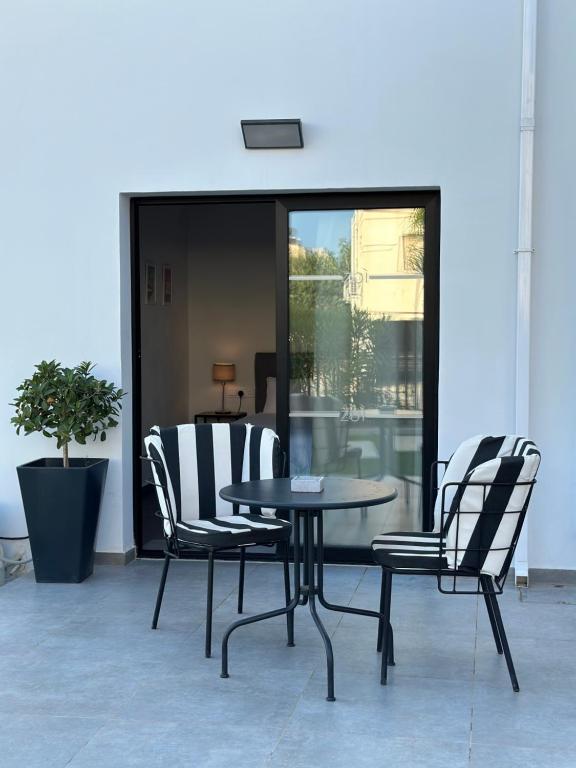 a table and chairs sitting on a patio at Zoi Ayia Napa in Ayia Napa