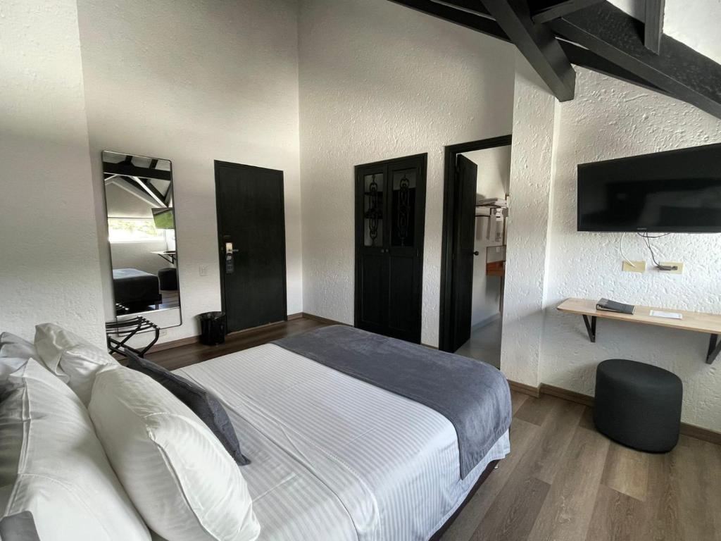 Postel nebo postele na pokoji v ubytování Hotel Santiago de Arma