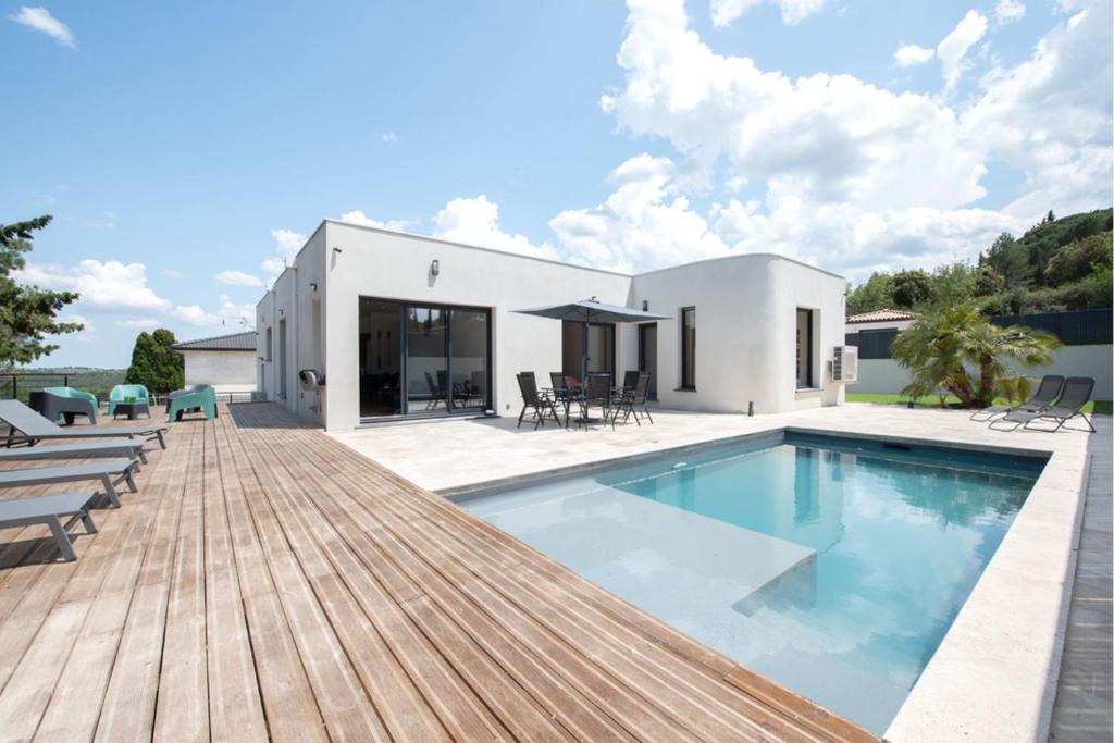 ein Haus mit einem Pool und einer Holzterrasse in der Unterkunft Exceptional villa with swimming pool in Palaja