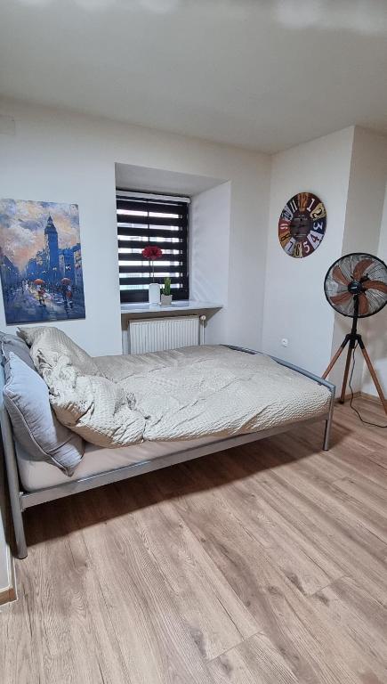a bedroom with a bed and a window at Apartma Rešer in Črna na Koroškem