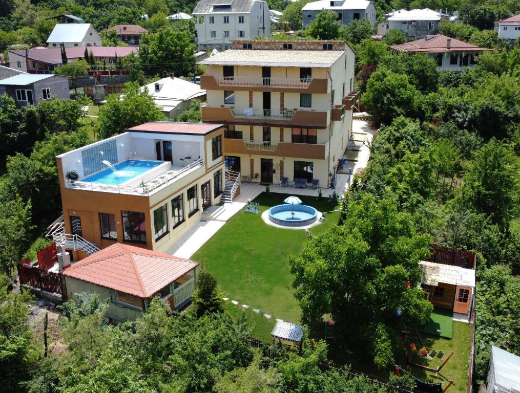 an aerial view of a house with a swimming pool at Hotel Legiandro Surami in Surami