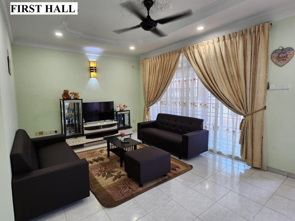 a living room with two couches and a tv at Galaxy Guest Home by Ipoh Maju Stay in Ipoh