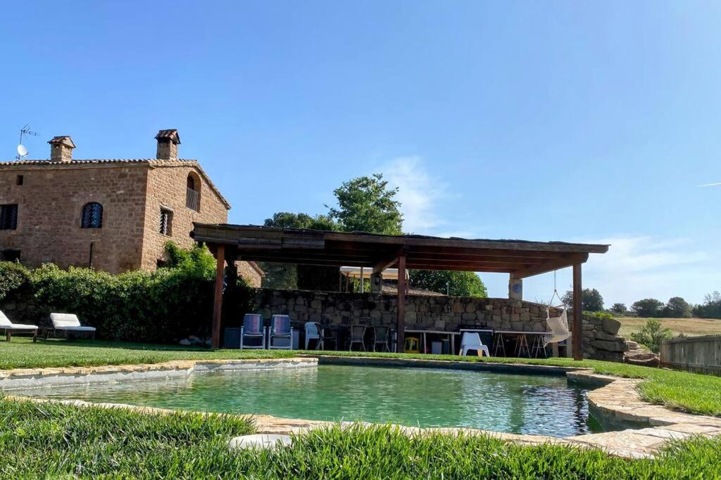 a swimming pool in a yard with a gazebo at Vila-seca, vine i desconnecta! in Aguilar de Segarra
