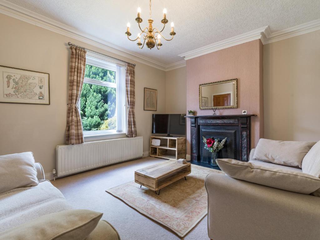 a living room with a couch and a fireplace at Cosy 2 bedroom house in the heart of Morpeth in Morpeth