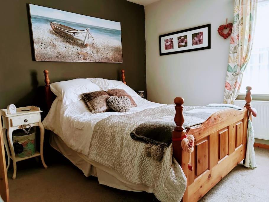 a bedroom with a bed and a painting on the wall at House - Alton Towers,Peak District,Wildlife Park in Leek