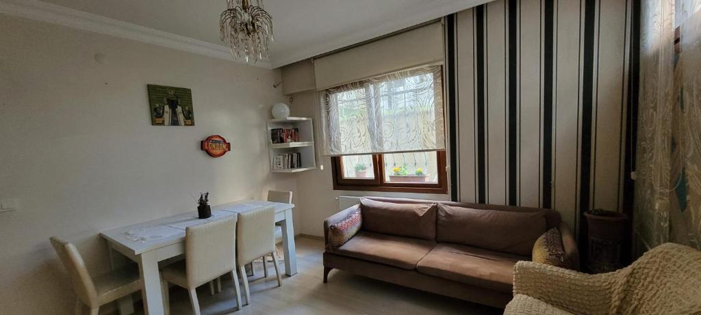 a living room with a couch and a table at An Easy Transport and Quiet Apartment in Istanbul in Istanbul