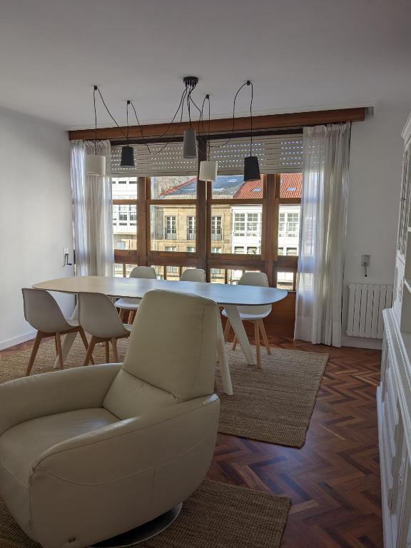 a living room with a table and chairs and a couch at Mirador de Ferradores in Betanzos