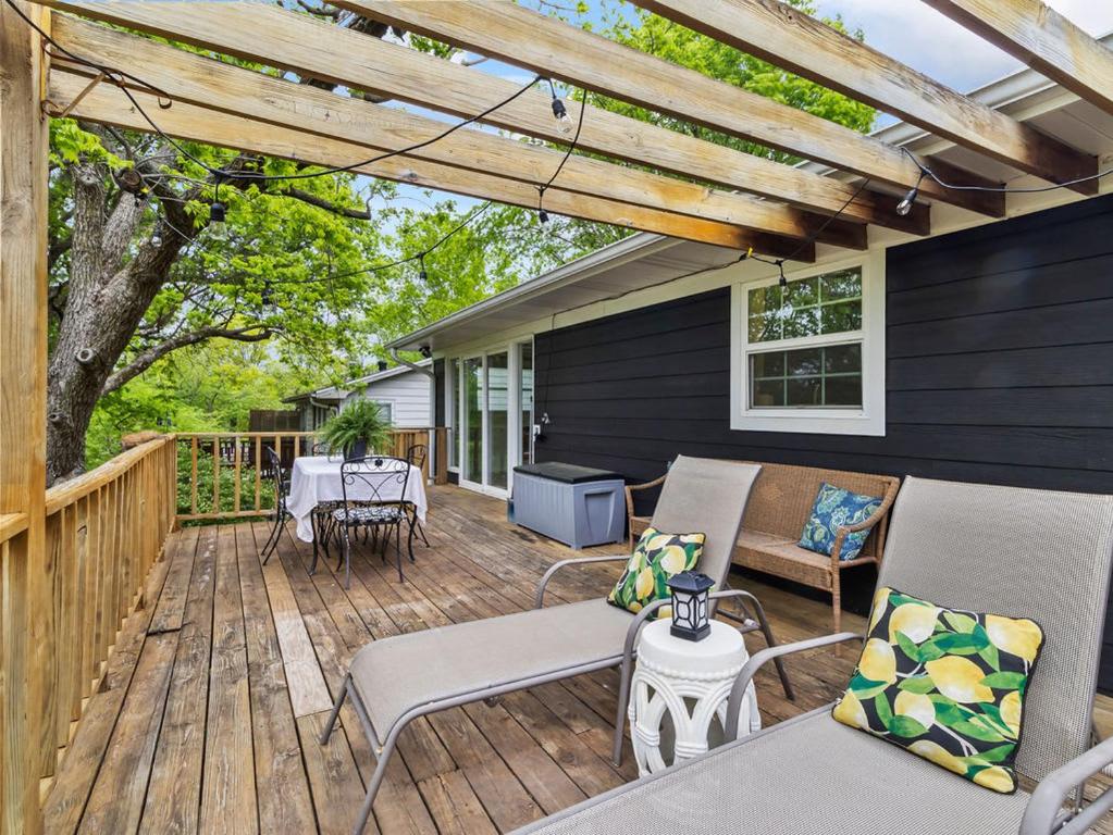 a wooden deck with chairs and a table on a house at Honeysuckle Hideaway in Fayetteville