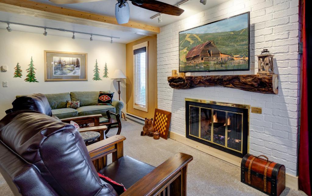 a living room with a couch and a fireplace at Bear Claw 104 - Bear Claw I Building in Steamboat Springs