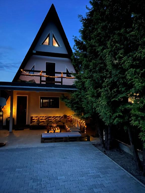 a house with a bench in front of a building at Bunloc House in Braşov