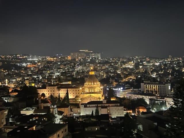 a view of a city at night at Aida Magic of Nazareth - Guesthouse in Nazareth
