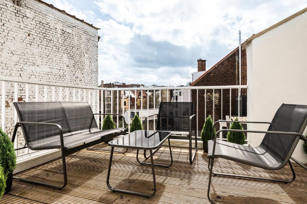a balcony with chairs and a table on a building at Brussels centre Bnb Sablon I, II et V in Brussels