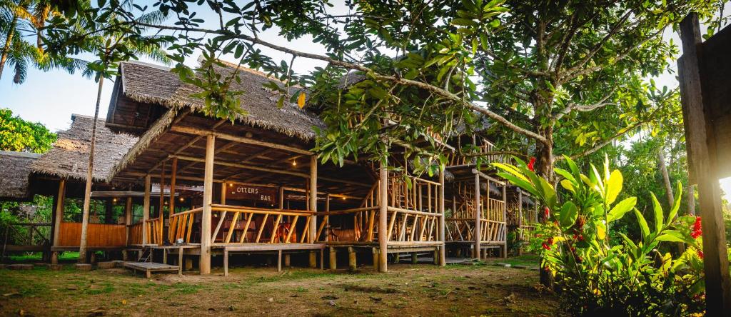 una gran casa de madera con techo en Tres Chimbadas Lake Lodge en Tambopata