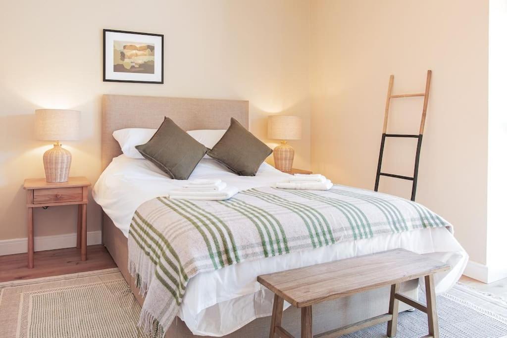 En eller flere senge i et værelse på The Barn in Longhope - Luxury Barn Conversion