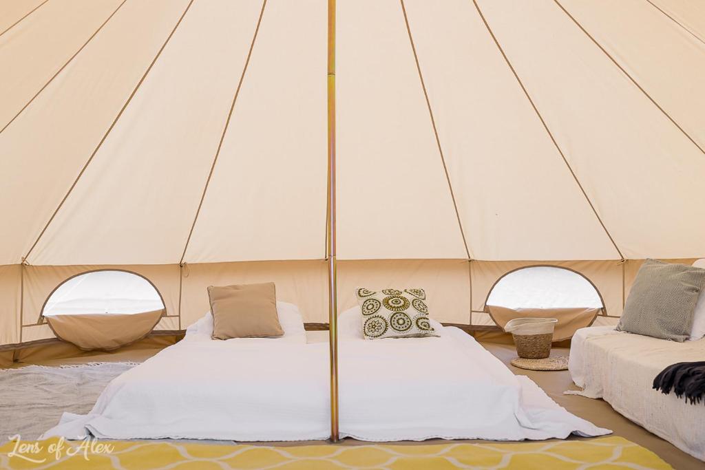 a tent with two beds in a room at Faleza23 in Olimp