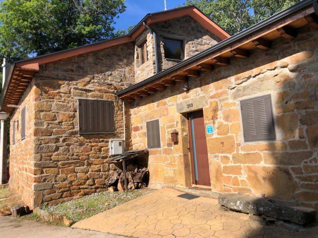 a stone building with a door on the side of it at SANABRIA - Palacio de La Cuesta in Palacios de Sanabria