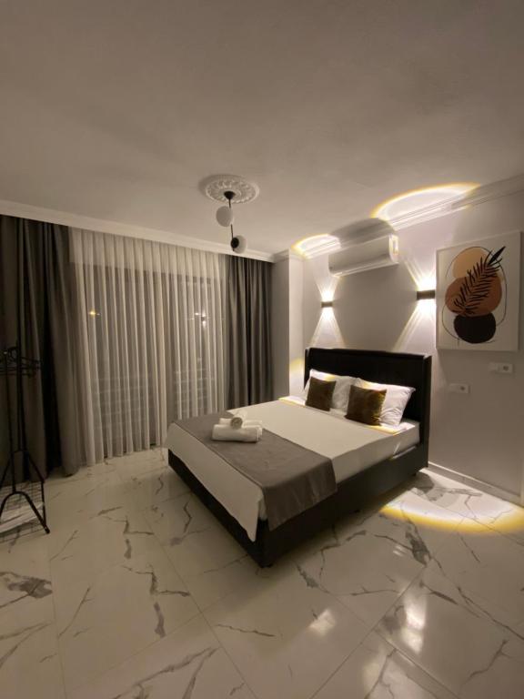 a bedroom with a bed in a room with marble floors at Bavella Boutique Hotel in Pamukkale