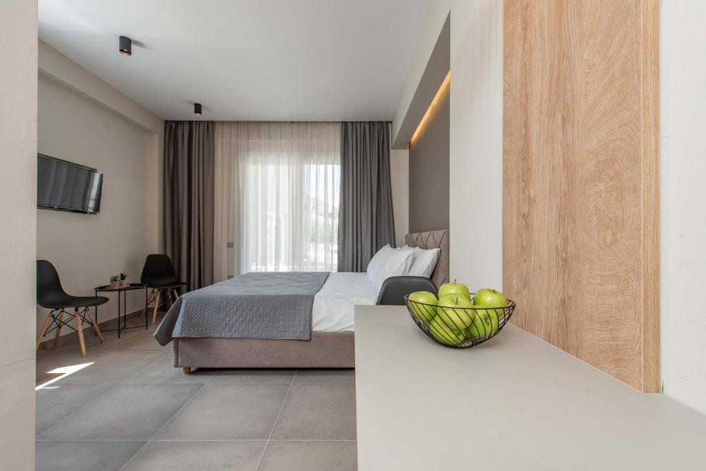 a hotel room with a bed and a bowl of fruit on a counter at Val Del Mar in Skala Fourkas