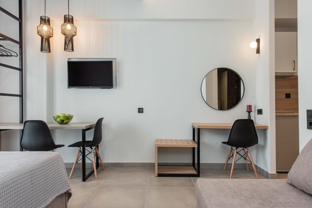 a bedroom with a bed and a table and a mirror at Val Del Mar in Skala Fourkas