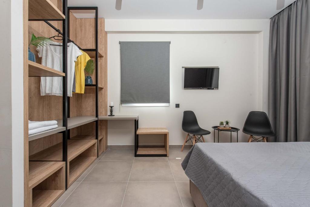 a bedroom with a bed and a desk and a chalkboard at Val Del Mar in Skala Fourkas